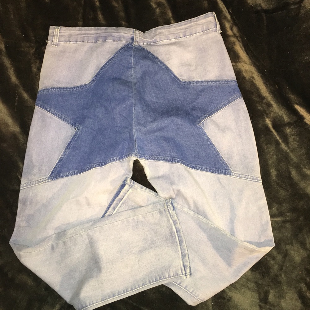 LIGHT BLUE JEANS WITH A BIG DARK BLUE STAR IN BACK